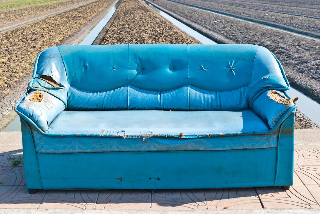 sofa left outside waiting to be removed